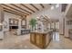 Gourmet kitchen featuring beamed ceilings, an island, and stainless steel appliances at 3217 N Piedra Cir, Mesa, AZ 85207