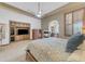 Comfortable main bedroom with a fireplace and a ceiling fan, offering a cozy and relaxing atmosphere at 3217 N Piedra Cir, Mesa, AZ 85207