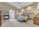 Beautiful main bedroom featuring a fireplace, a ceiling fan, and stylish decorations at 3217 N Piedra Cir, Mesa, AZ 85207