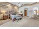 Spacious main bedroom featuring a ceiling fan, rustic wood wall, and warm lighting for a cozy atmosphere at 3217 N Piedra Cir, Mesa, AZ 85207