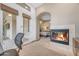 Bright office featuring a fireplace and archway views into the main bedroom at 3217 N Piedra Cir, Mesa, AZ 85207