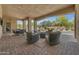 Covered outdoor living space features seating and dining with views of the pool at 3217 N Piedra Cir, Mesa, AZ 85207