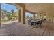 Covered outdoor living space features dining with views of the pool and landscaping at 3217 N Piedra Cir, Mesa, AZ 85207
