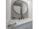 Stylish powder room featuring modern vanity, black faucet, and round mirror at 3233 E Sequoia Dr, Phoenix, AZ 85050