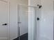 Modern bathroom featuring a glass shower, white tile, and dark fixtures at 3233 E Sequoia Dr, Phoenix, AZ 85050
