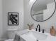 Stylish bathroom features a round mirror and modern fixtures at 3233 E Sequoia Dr, Phoenix, AZ 85050