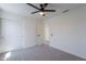 Bright bedroom features neutral walls, carpet, ceiling fan and closet at 3233 E Sequoia Dr, Phoenix, AZ 85050