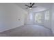 Bright bedroom with vaulted ceiling, ceiling fan, carpet, and windows that provide ample natural light at 3233 E Sequoia Dr, Phoenix, AZ 85050