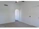 Neutral-toned bedroom with carpet and white walls, and an arched doorway to another room at 3233 E Sequoia Dr, Phoenix, AZ 85050