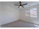 Neutral bedroom features a ceiling fan and a window providing natural light at 3233 E Sequoia Dr, Phoenix, AZ 85050