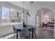 Bright dining area with modern chandelier, neutral walls, and large windows offering backyard views at 3233 E Sequoia Dr, Phoenix, AZ 85050