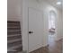 Hallway leading to living room, featuring staircase and storage area at 3233 E Sequoia Dr, Phoenix, AZ 85050