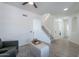 Bright living room showcasing staircase, arched entryway, and neutral decor at 3233 E Sequoia Dr, Phoenix, AZ 85050
