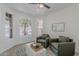Cozy living room features two green armchairs, bright windows, and neutral decor at 3233 E Sequoia Dr, Phoenix, AZ 85050