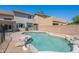 Backyard pool with rock features, privacy fence, and view of the home's exterior at 3233 E Sequoia Dr, Phoenix, AZ 85050