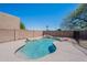 Beautiful backyard pool with rock feature, privacy fence, and desert landscaping at 3233 E Sequoia Dr, Phoenix, AZ 85050