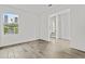 Bright bedroom with tile floors, a large window, and access to the staircase at 325 E Coronado Rd # 8, Phoenix, AZ 85004