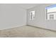 Bright, empty bedroom with large windows and neutral carpeting, awaiting personal touches at 325 E Coronado Rd # 8, Phoenix, AZ 85004