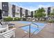 Inviting community pool area with sun loungers, surrounded by modern townhome residences at 325 E Coronado Rd # 8, Phoenix, AZ 85004