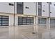 Modern townhome exterior featuring glass garage doors and neutral color palette at 325 E Coronado Rd # 8, Phoenix, AZ 85004