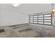 Spacious garage with concrete flooring and a contemporary glass door at 325 E Coronado Rd # 8, Phoenix, AZ 85004