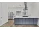 Modern kitchen features stainless steel appliances, a large island, and sleek white countertops at 325 E Coronado Rd # 8, Phoenix, AZ 85004