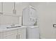 Efficient laundry area with stacked washer/dryer and sink within modern cabinetry at 325 E Coronado Rd # 8, Phoenix, AZ 85004