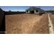 Backyard of a new home under construction with scaffolding around the house, a dirt lot and block wall at 32615 N Newby Dr, San Tan Valley, AZ 85143