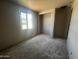 An unfinished bedroom in a new home build with drywall walls, gray flooring and an alcove for a closet at 32615 N Newby Dr, San Tan Valley, AZ 85143