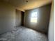 An unfinished bedroom in a new home build with drywall walls, gray flooring and a window at 32615 N Newby Dr, San Tan Valley, AZ 85143