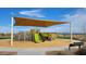 Shaded community playground with slides, climbing structures, and a soft ground surface for safety at 32615 N Newby Dr, San Tan Valley, AZ 85143