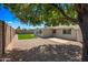 Backyard with shade tree, gravel ground cover, artificial grass and patio at 338 W Taro Ln, Phoenix, AZ 85027
