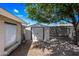 Backyard with shed, large shade tree and gravel ground cover at 338 W Taro Ln, Phoenix, AZ 85027