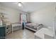 This bedroom has tiled floors, a ceiling fan, and is staged as a room at 338 W Taro Ln, Phoenix, AZ 85027