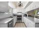 Bright kitchen with stainless steel appliances, white cabinetry, and ample counter space at 338 W Taro Ln, Phoenix, AZ 85027