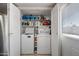 Convenient laundry room featuring a washer, dryer, and shelving for storage at 338 W Taro Ln, Phoenix, AZ 85027