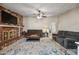 Open living room with brick fireplace, ceiling fan, and comfortable seating at 338 W Taro Ln, Phoenix, AZ 85027