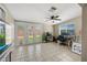 Bright living room with tile floors, ceiling fan, and french doors to the backyard at 338 W Taro Ln, Phoenix, AZ 85027