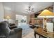 Open living room featuring a brick fireplace and access to the backyard at 338 W Taro Ln, Phoenix, AZ 85027
