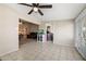Open-concept living room with tile flooring leading to a cozy Gathering room with a ceiling fan at 338 W Taro Ln, Phoenix, AZ 85027