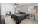 This main bedroom has tile floors, a ceiling fan, and ensuite bathroom at 338 W Taro Ln, Phoenix, AZ 85027