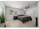 This main bedroom has tile floors, a ceiling fan, and a window that looks out to the neighborhood at 338 W Taro Ln, Phoenix, AZ 85027