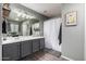Well-lit bathroom featuring vanity, sink, and shower/tub with white shower curtain at 3730 S Chaparral Rd, Apache Junction, AZ 85119