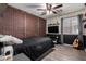 Modern bedroom with brick wall accent, wood plank floors and flat screen tv at 3730 S Chaparral Rd, Apache Junction, AZ 85119