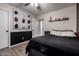 Bedroom with a black accent wall, wood floors, sports decor, and white door at 3730 S Chaparral Rd, Apache Junction, AZ 85119