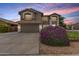 Inviting home exterior featuring neutral paint, a two-car garage, and a well-maintained front yard at 3730 S Chaparral Rd, Apache Junction, AZ 85119