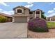 Beautiful exterior view of home showcasing lush purple landscaping and a two-car garage at 3730 S Chaparral Rd, Apache Junction, AZ 85119