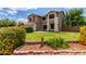 Beautifully landscaped front yard with lush lawn, colorful bushes, and a charming two-story home at 3730 S Chaparral Rd, Apache Junction, AZ 85119