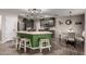 A large kitchen island with seating complements the gray cabinets and eat in kitchen space at 3730 S Chaparral Rd, Apache Junction, AZ 85119