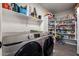 The laundry room contains appliances and floor to ceiling shelves at 3730 S Chaparral Rd, Apache Junction, AZ 85119